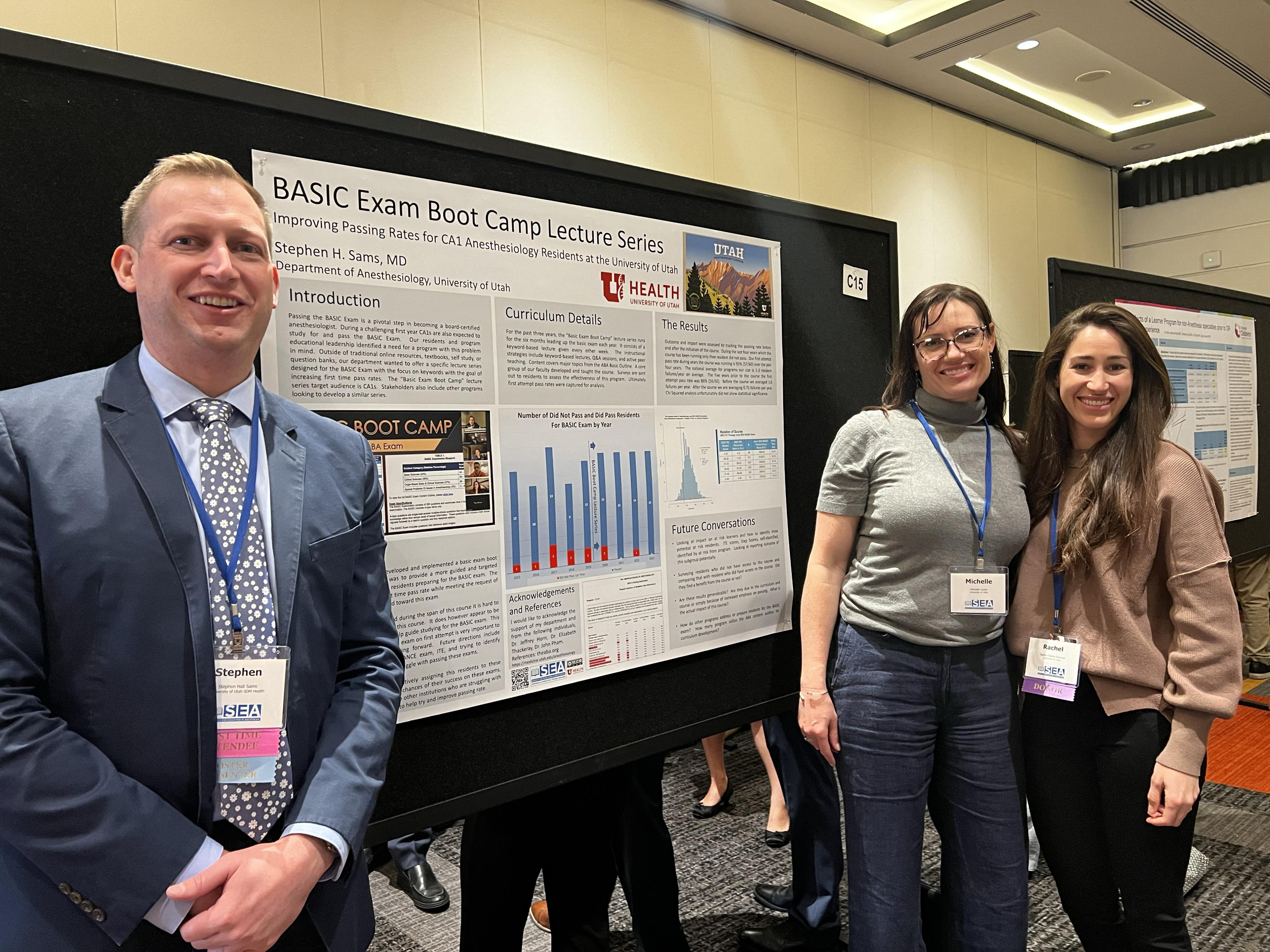 Three people standing in front of a presentation board smiling for a photo.