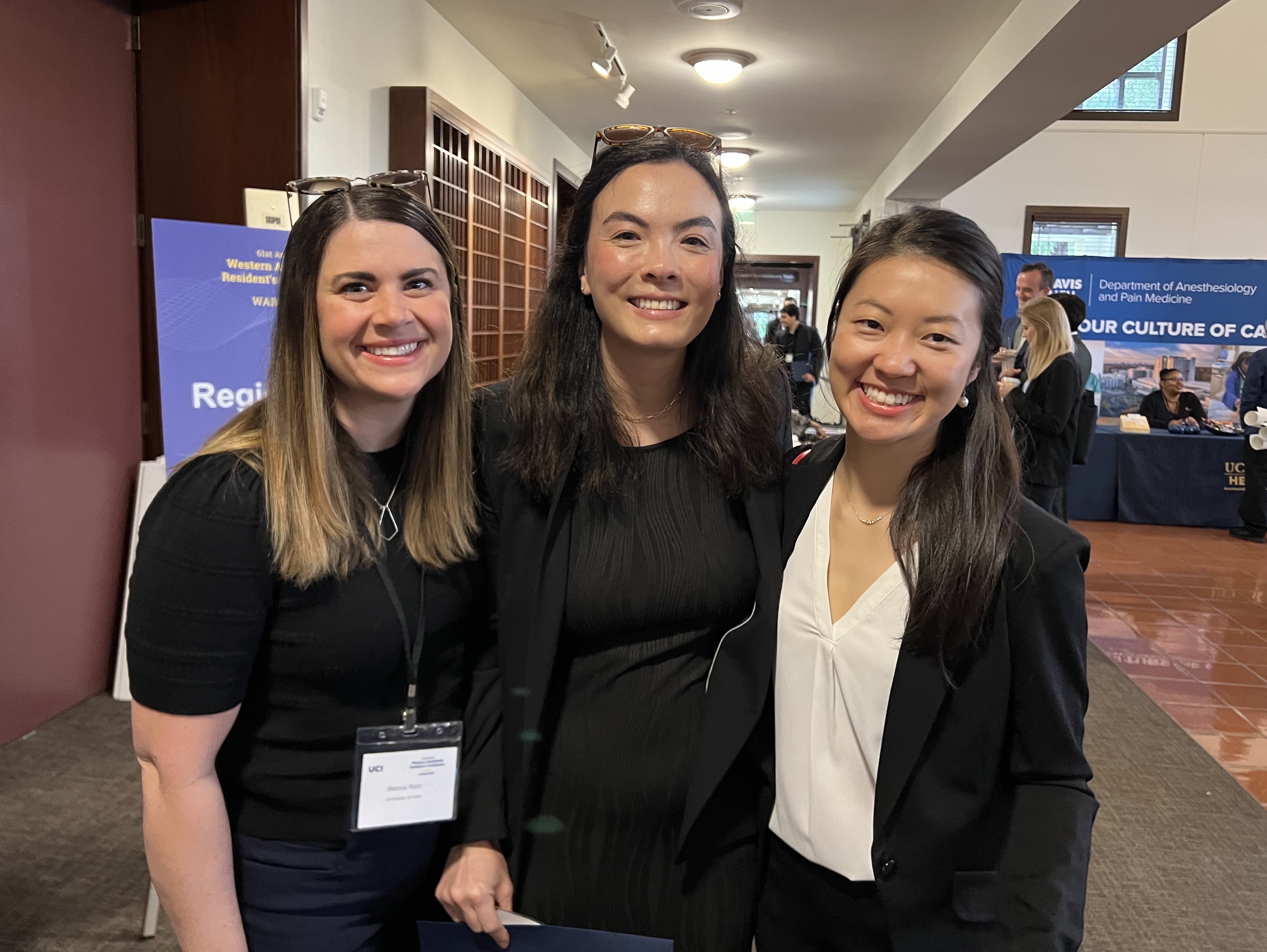 Three anesthesiology residents posing for a photo at the conference. 