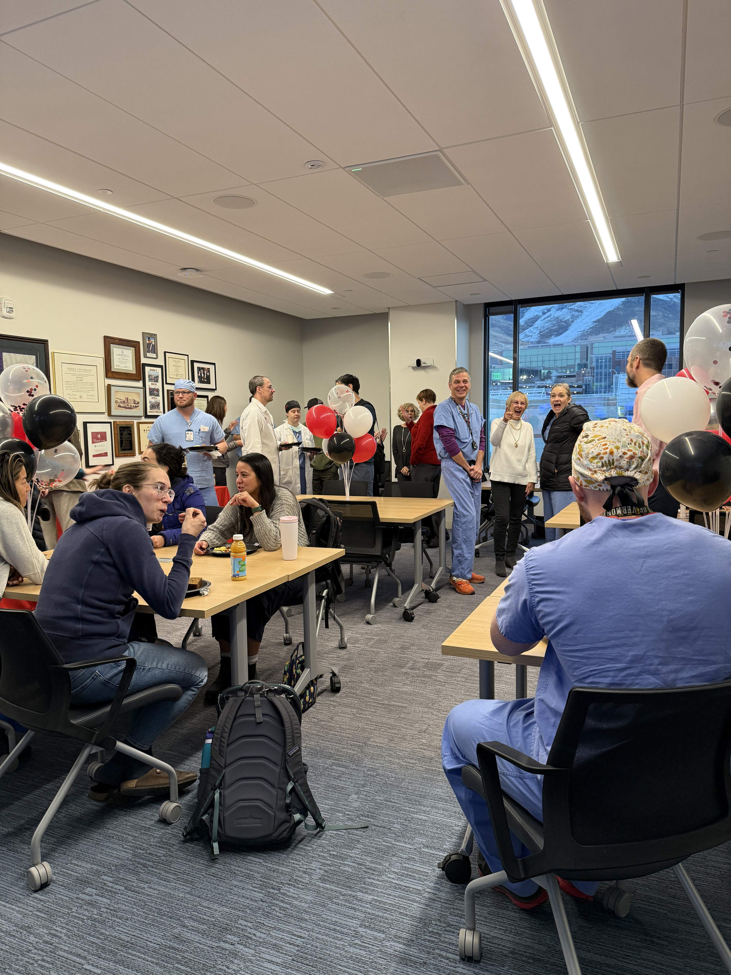 The Michael K Cahalan MD Conference Room full of department members eating food and celebrating the dedication.