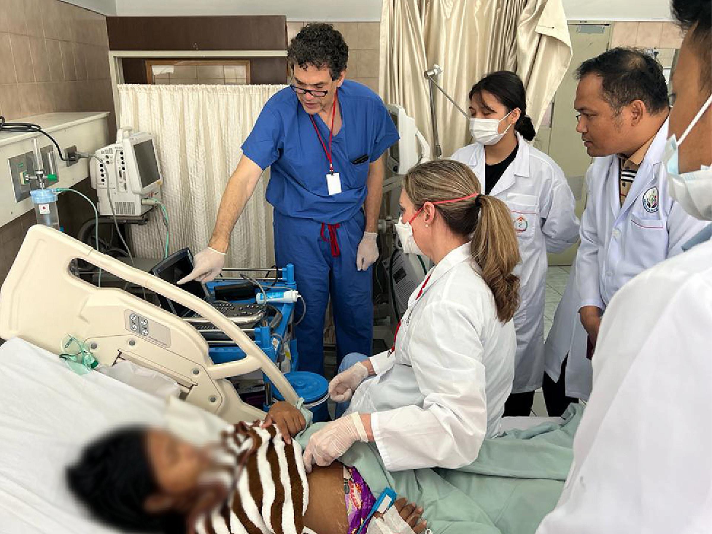  Dr Candice Morrissey and Dr. Steve Rondeau colleague teaching echocardiography in a woman thought to have cardiomyopathy in pregnancy at the Women’s Hospital in Phnom Penh.
