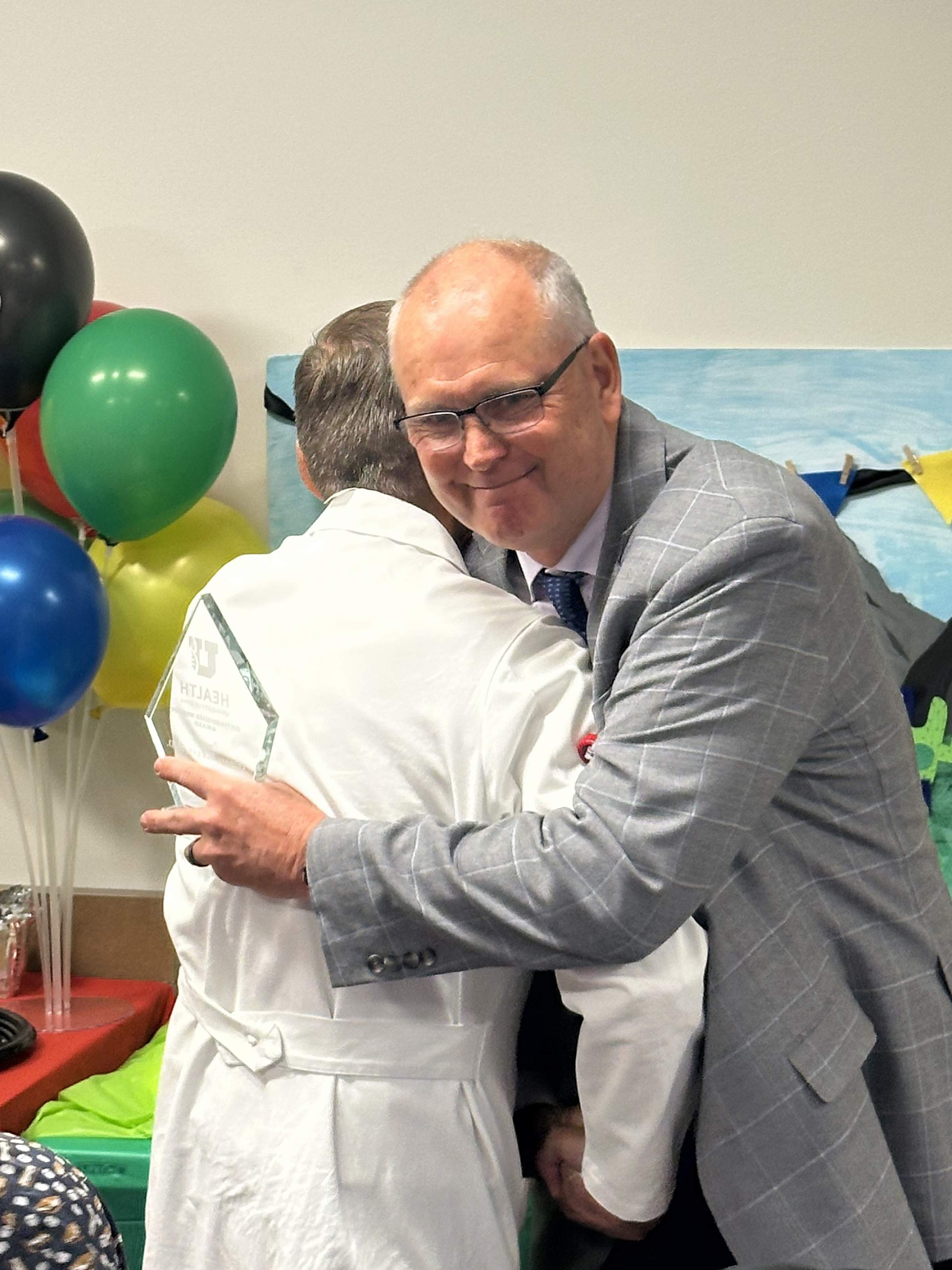 Dr. Talmage Egan and Ken Johnson hug at Dr. Johnson’s farewell party.